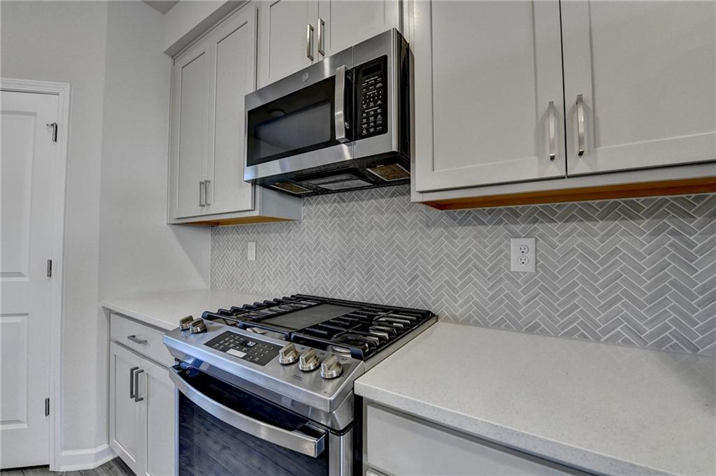 3661 Willingham Run Southwest Marietta, GA 30008 - Photo 11 of 46 a kitchen with microwave cabinets and stove top oven