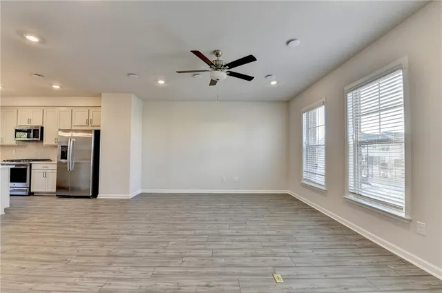 a view of a kitchen with furniture and a ceiling fan