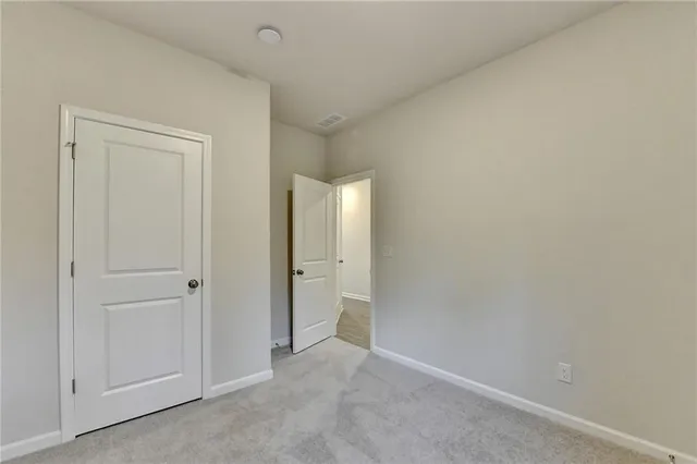 a view of an empty room with closet area