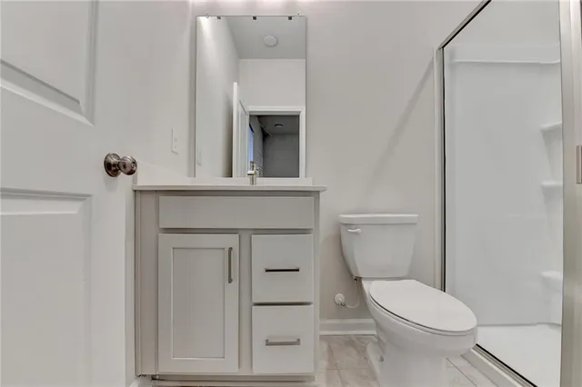 a white toilet sitting next to a bathroom sink