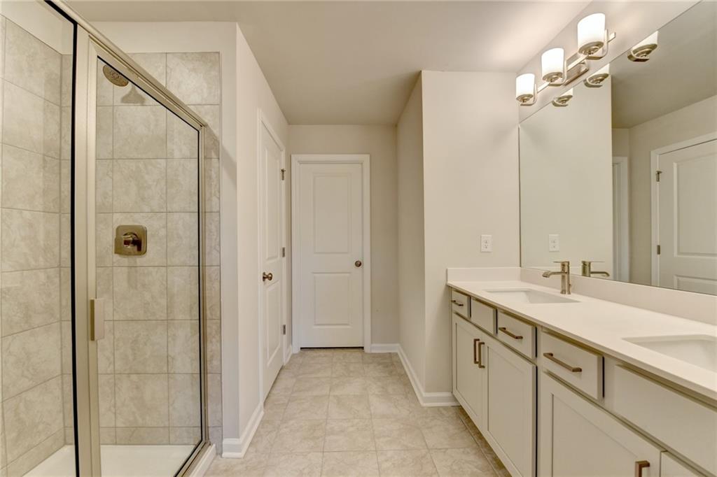 3661 Willingham Run Southwest Marietta, GA 30008 - Photo 34 of 46 a bathroom with a double vanity sink mirror and shower