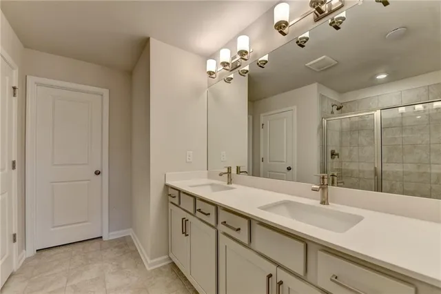 a bathroom with a sink double vanity and a mirror