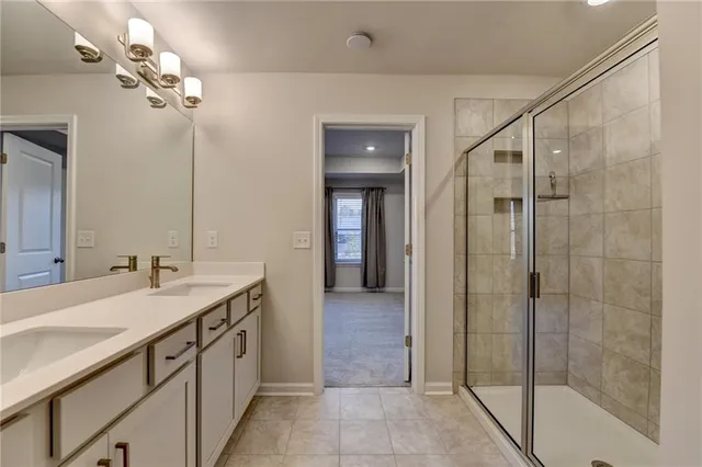 a bathroom with a double vanity sink a large mirror and a shower