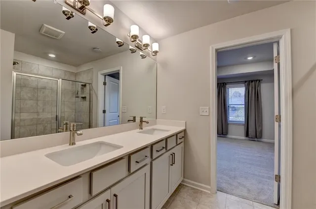 a bathroom with a sink double vanity and a mirror