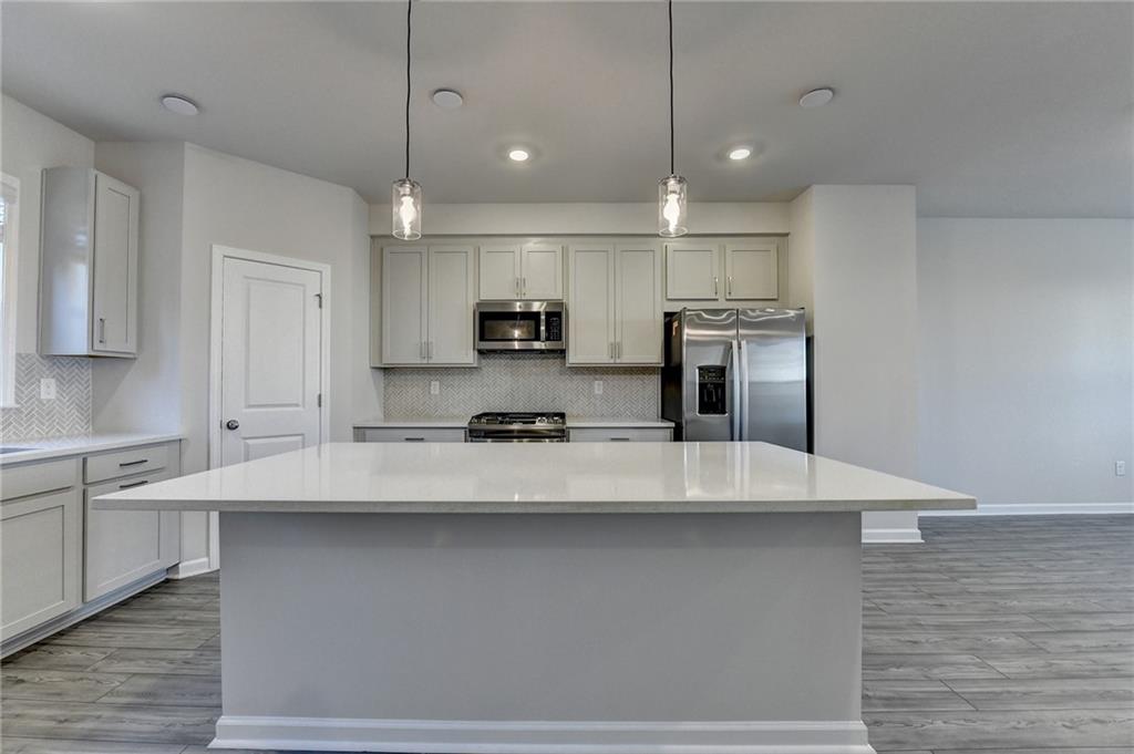 3661 Willingham Run Southwest Marietta, GA 30008 - Photo 6 of 46 a large kitchen with kitchen island a sink stainless steel appliances and cabinets