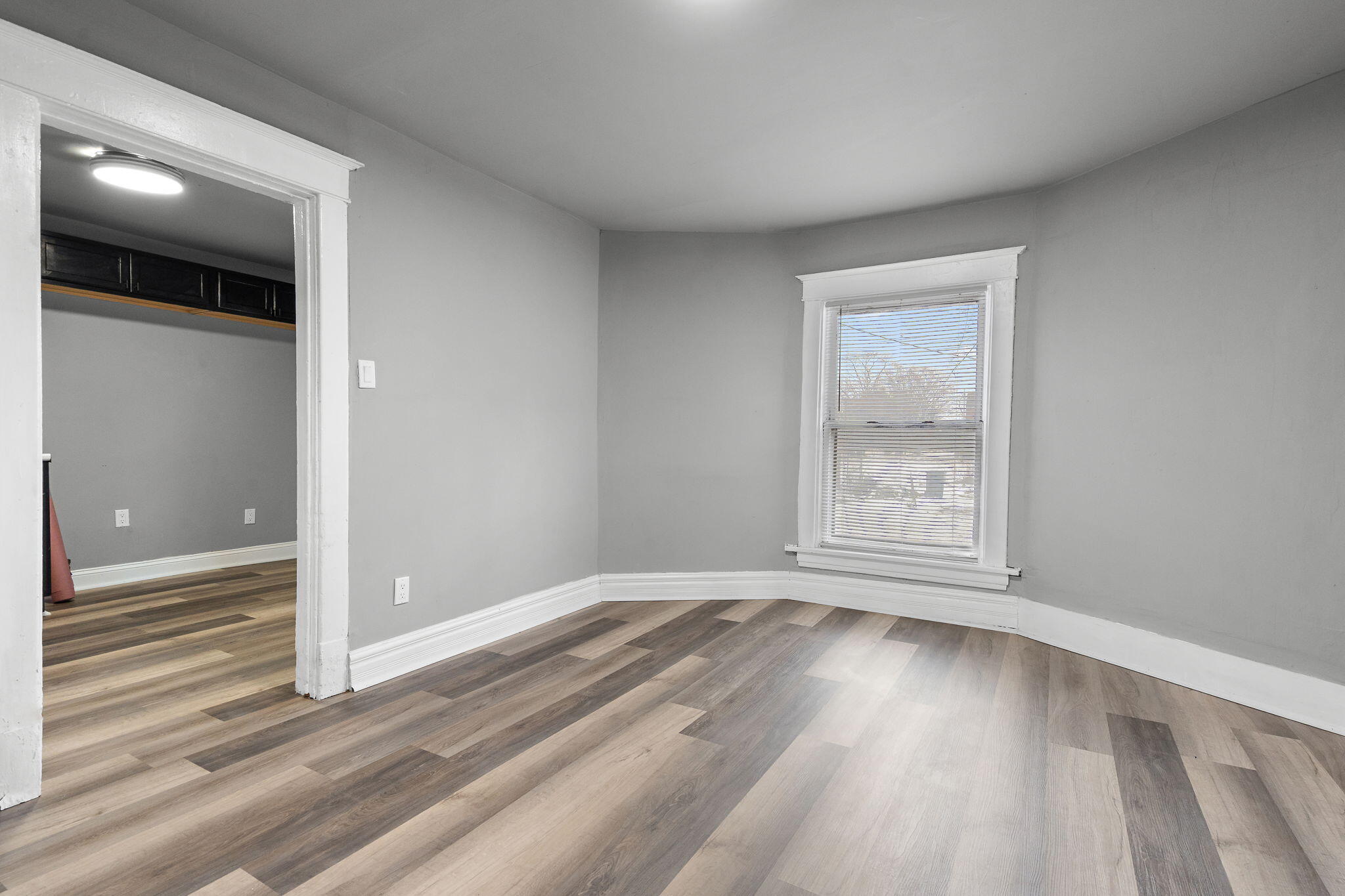 565 Jackson Street Gary, IN 46402 - Photo 7 of 19 an empty room with wooden floor and windows