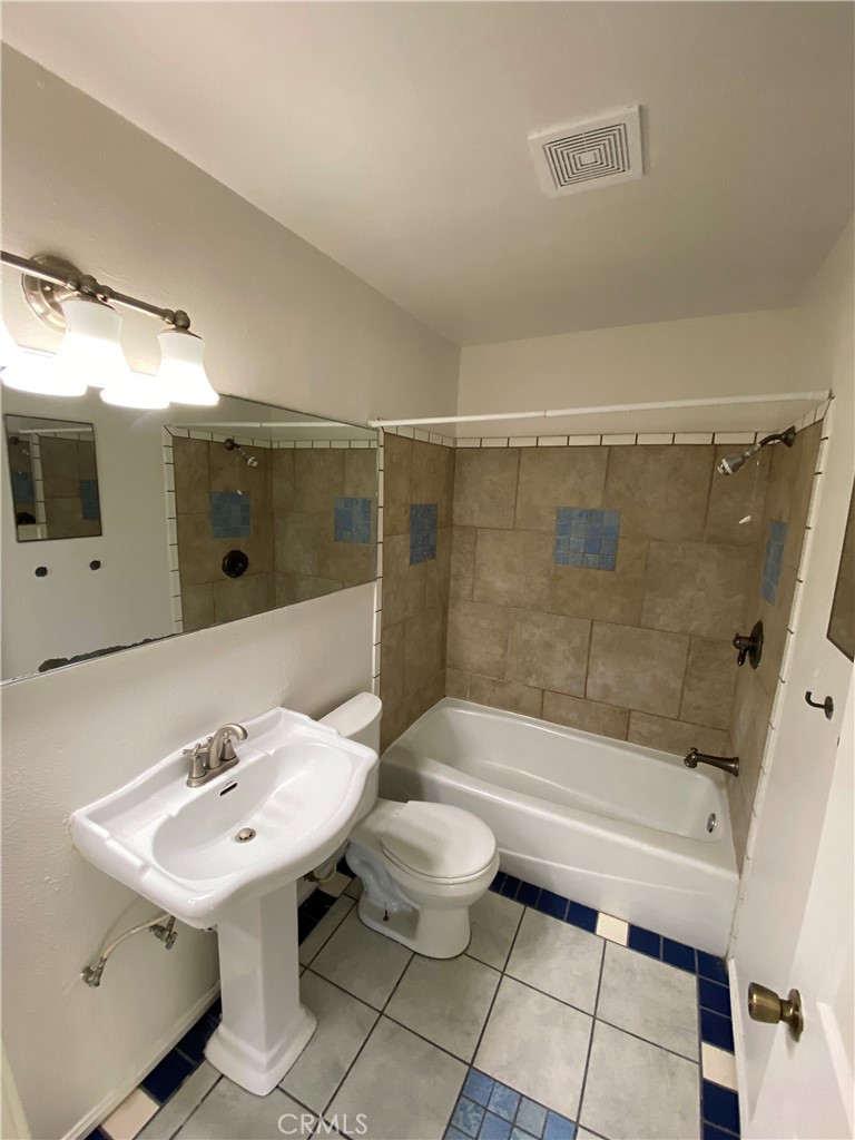 18746 Rock Springs Road Hesperia, CA 92345 - Photo 15 of 21 a bathroom with a sink a toilet and shower