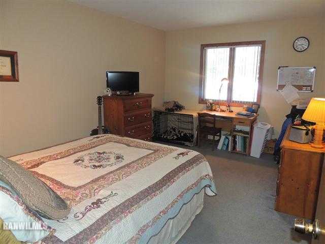 4702 Thorne Road Marengo, IL 60152 - Photo 9 of 12 a bed room with a bed and a television