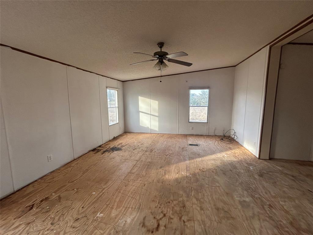 2300 County Road 3525 Dike, TX 75437 - Photo 11 of 14 an empty room with windows and cabinet