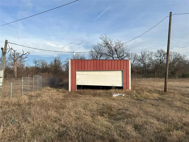 a view of a room with a big yard and potted plants
