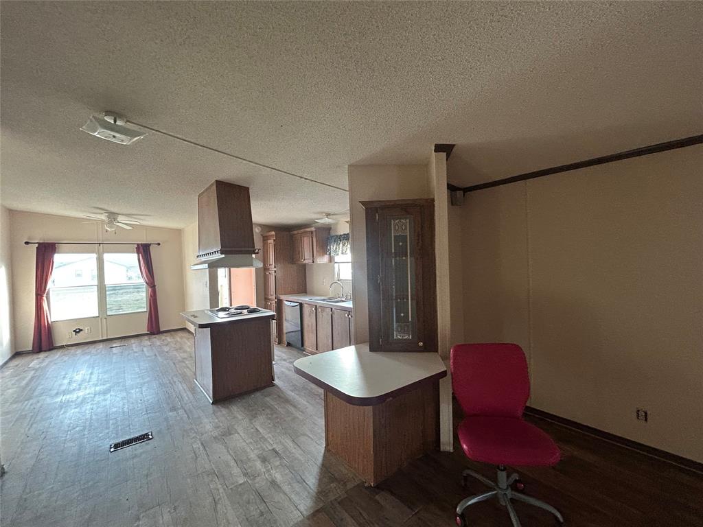 2300 County Road 3525 Dike, TX 75437 - Photo 9 of 14 a kitchen with sink refrigerator dining table and chairs