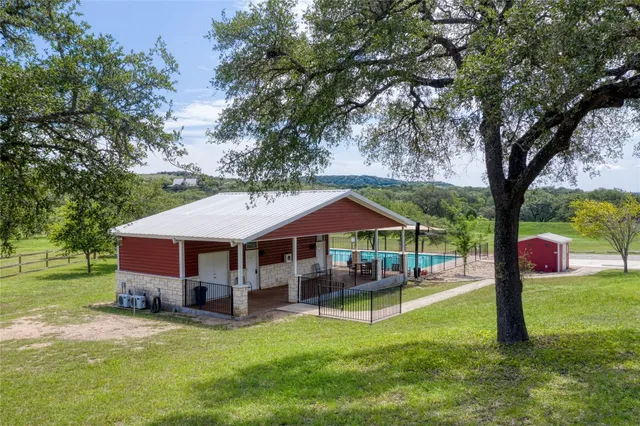 a swimming pool covered with tall trees