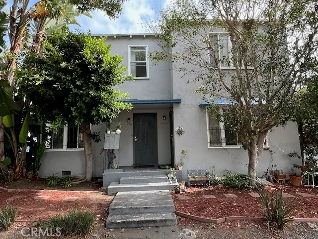a front view of a house with garden
