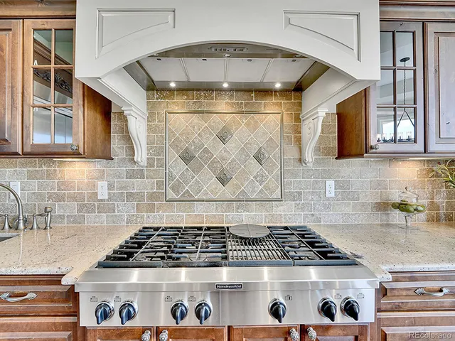 a stove top oven sitting inside of a kitchen