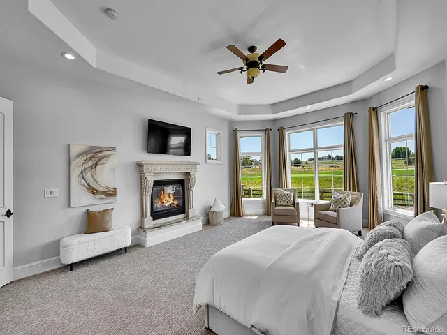 a spacious bedroom with a large bed and a fireplace