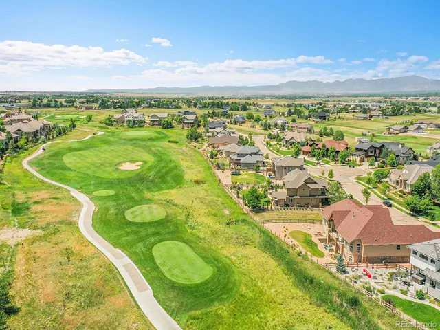 an aerial view of residential houses with outdoor space and swimming pool