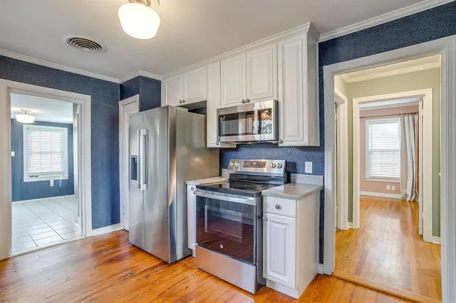 a kitchen with stainless steel appliances a stove a refrigerator and a sink