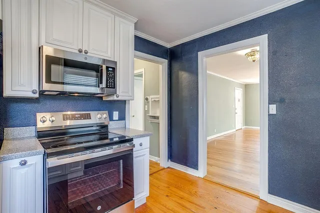 a kitchen with a stove and a microwave