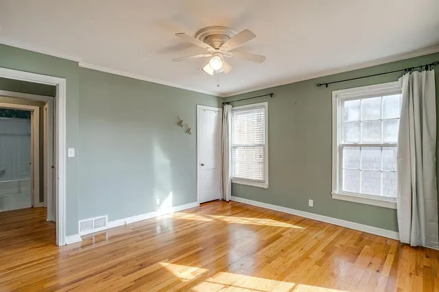 a view of an empty room and wooden floor