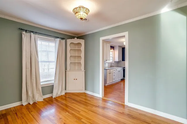 a view of a bedroom with wooden floor