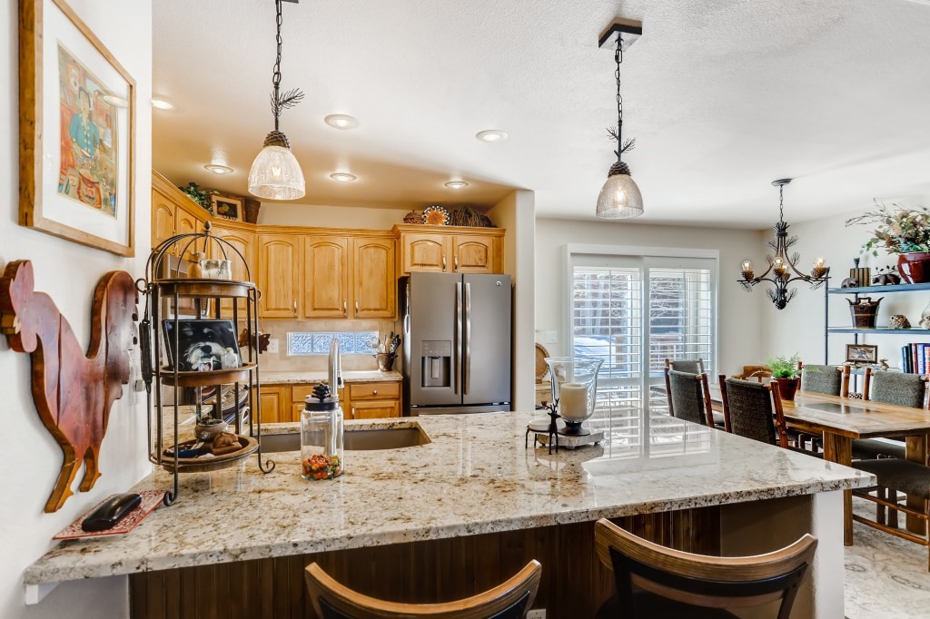 98 Lookout Ridge Drive, Unit 98 Dillon, CO 80435 - Photo 10 of 29 REMODELED Kitchen with expanded GRANITE Countertop, GRANITE Sink, TILE Backsplash, INSTANT HOT WATER Dispenser and NEW GE SLATE Appliances...