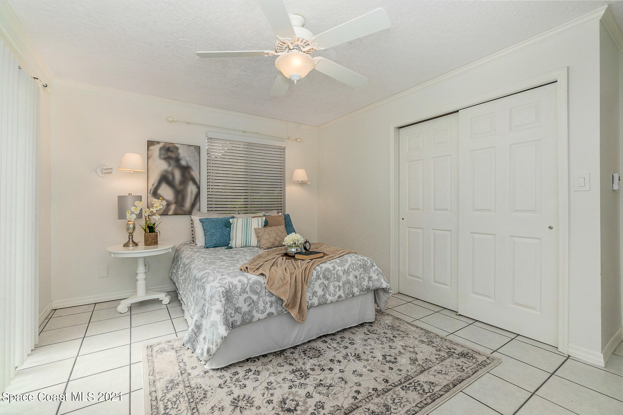 1805 Evers Road Melbourne, FL 32934 - Photo 11 of 29 a bed room with a bed and a chandelier