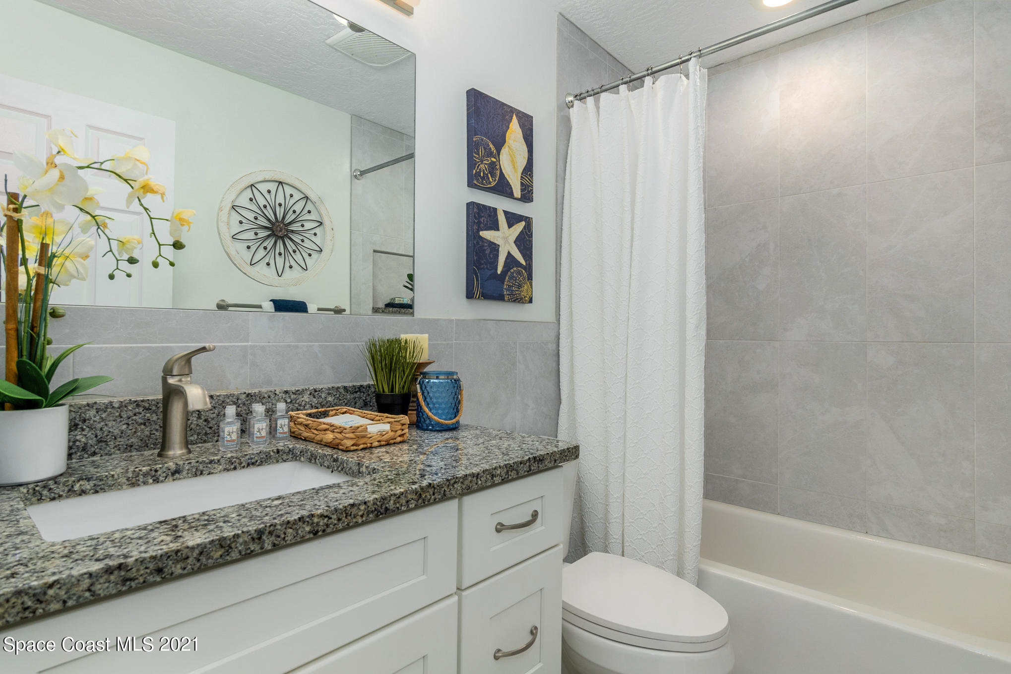 1805 Evers Road Melbourne, FL 32934 - Photo 14 of 29 a bathroom with a granite countertop sink a toilet and shower