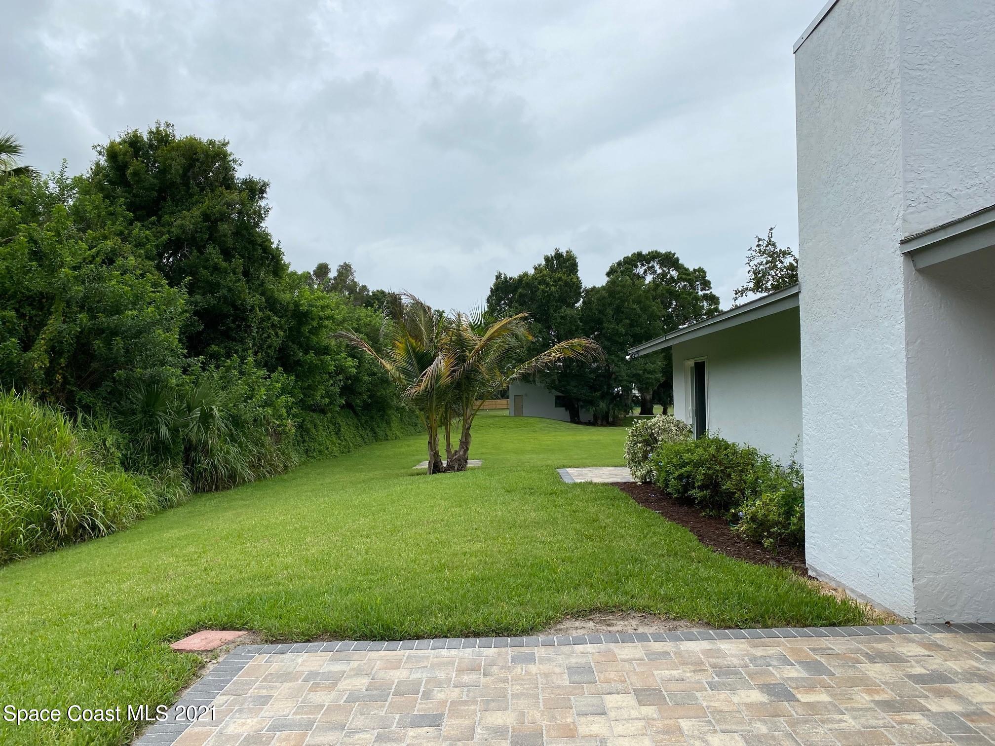 1805 Evers Road Melbourne, FL 32934 - Photo 17 of 29 a front view of a house with a yard and a garage
