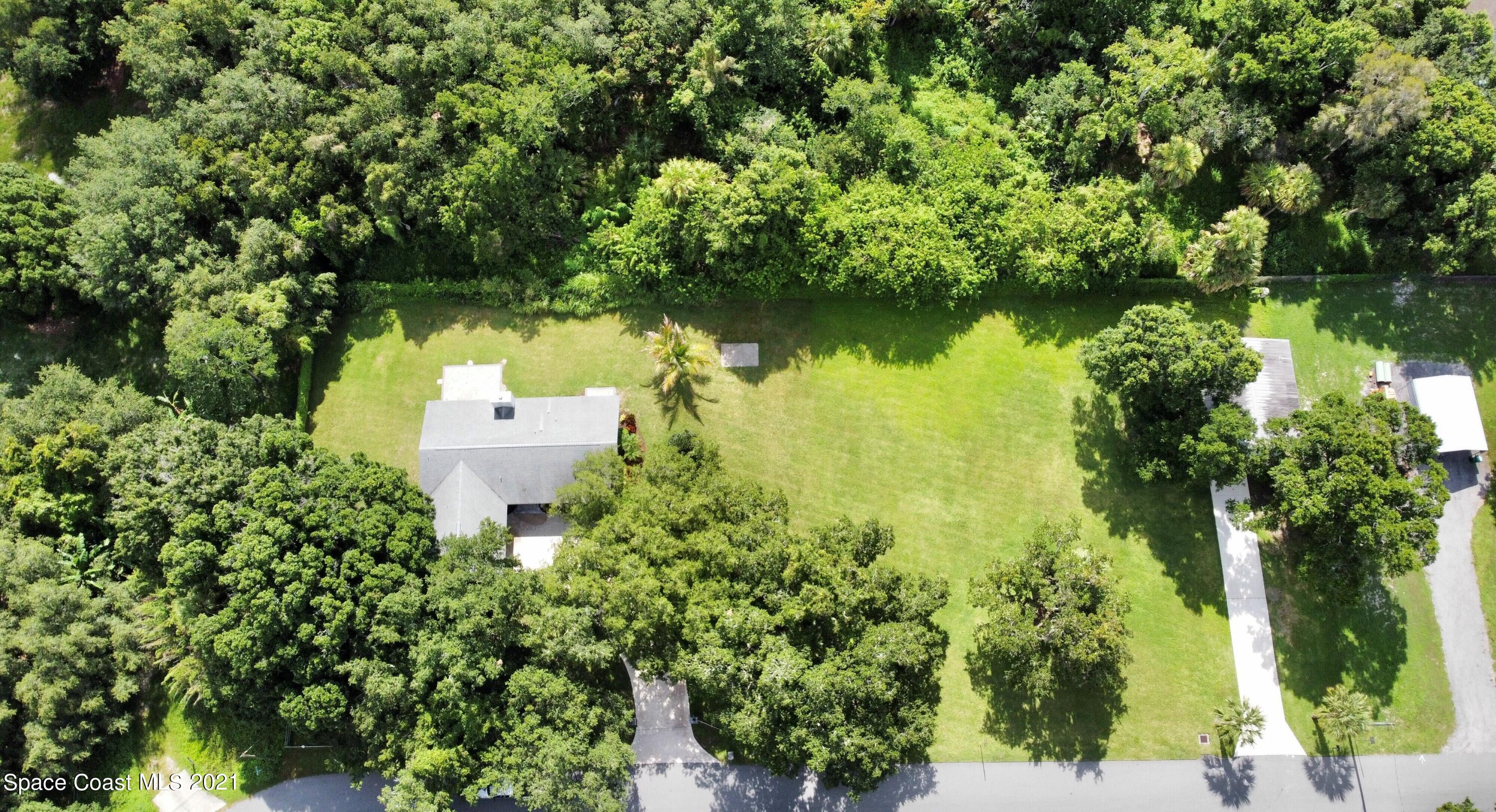 1805 Evers Road Melbourne, FL 32934 - Photo 19 of 29 an aerial view of a house with a yard and lake view