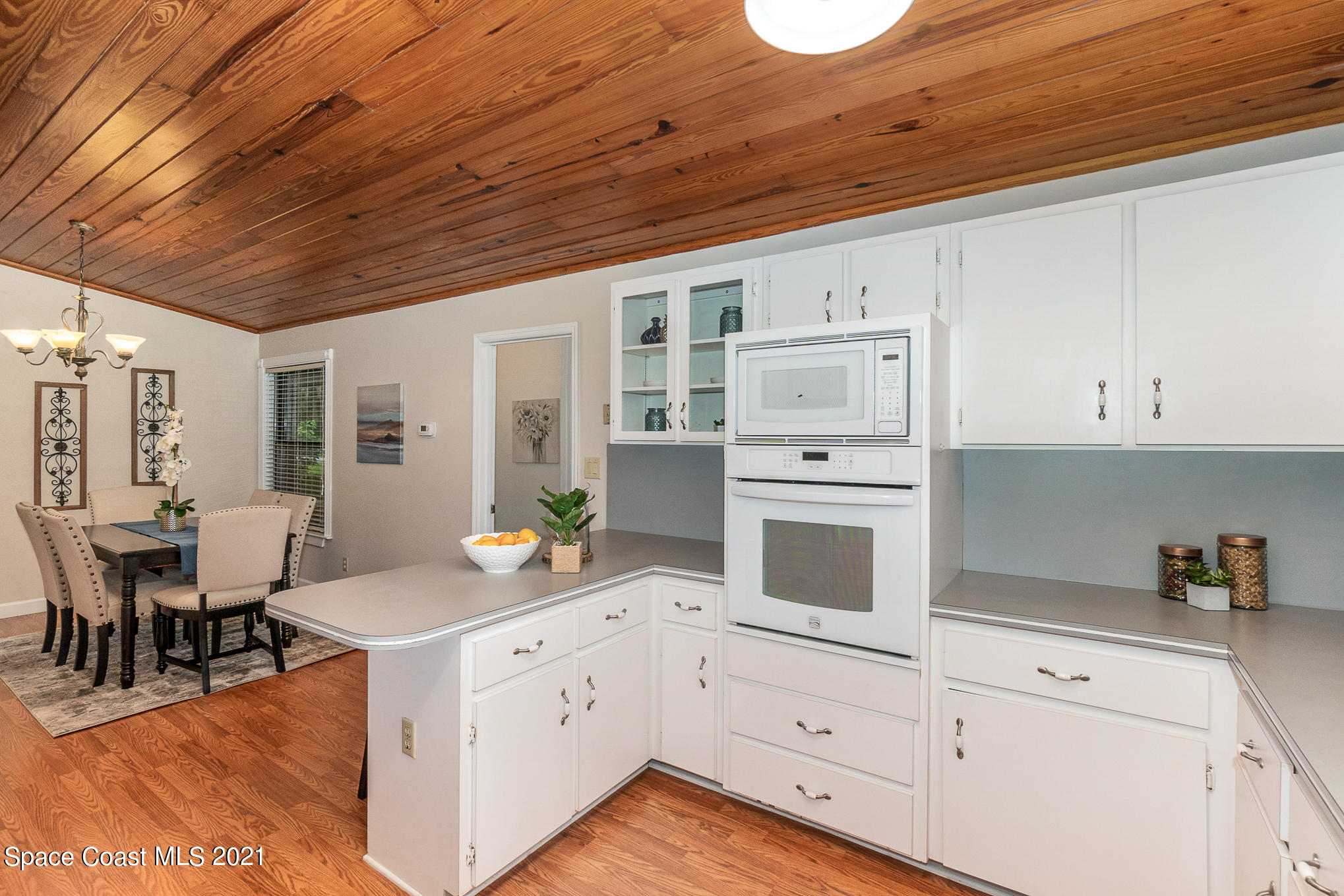 1805 Evers Road Melbourne, FL 32934 - Photo 8 of 29 a open kitchen with granite countertop white cabinets and white appliances
