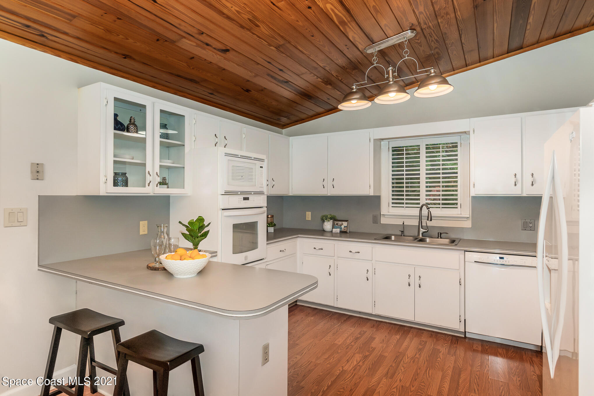 1805 Evers Road Melbourne, FL 32934 - Photo 9 of 29 a kitchen with a sink a cabinets and wooden floor