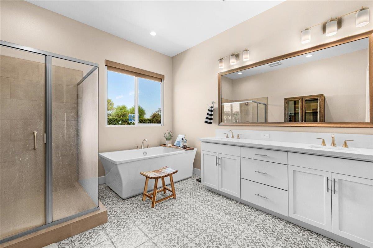 1003 Highland Road Madera, CA 93636 - Photo 37 of 73 a bathroom with a double vanity sink toilet mirror and bathtub