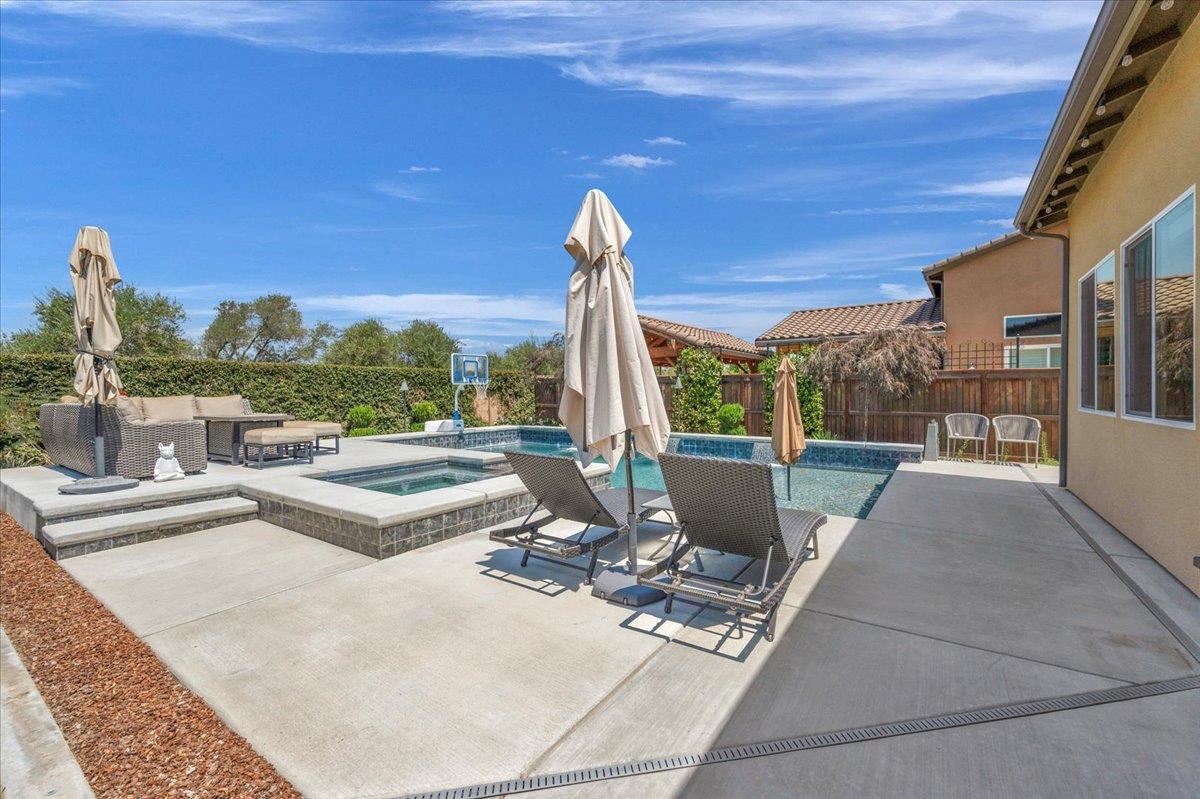 1003 Highland Road Madera, CA 93636 - Photo 49 of 73 a view of a patio with a dining table and chairs