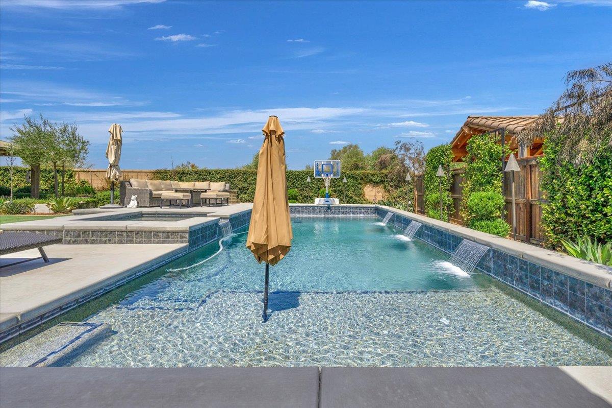 1003 Highland Road Madera, CA 93636 - Photo 51 of 73 a view of a swimming pool with a patio