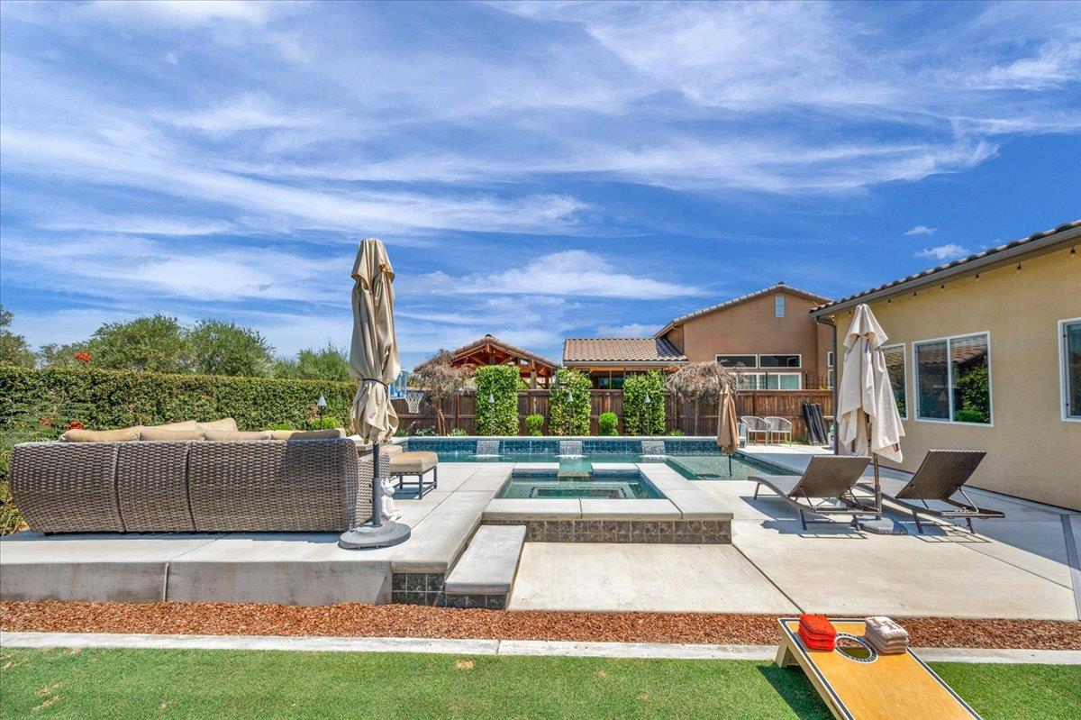 1003 Highland Road Madera, CA 93636 - Photo 56 of 73 a view of swimming pool with seating area and barbeque oven in the back yard