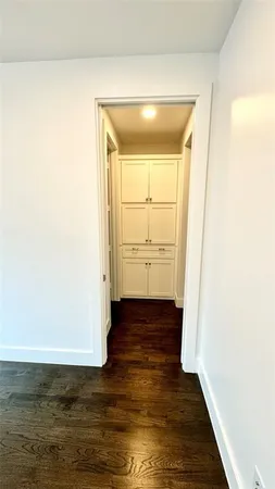 a view of walk in closet with empty racks