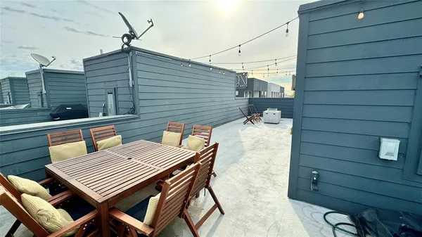 a view of a patio with a table and chairs and potted plants