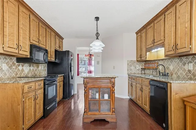 a kitchen with stainless steel appliances granite countertop a stove and a sink