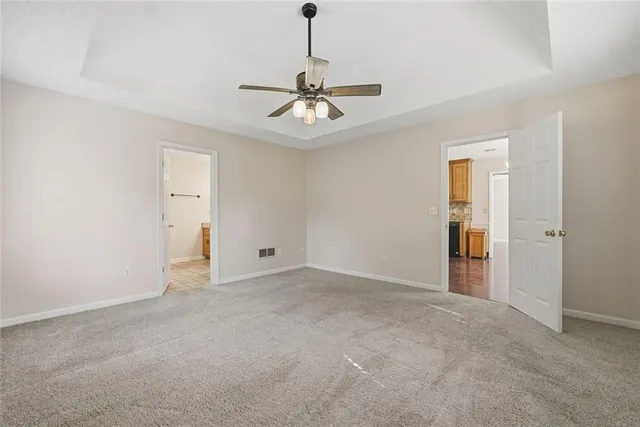 a view of a livingroom with a ceiling fan and window