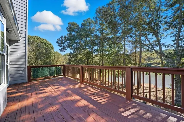 an empty room with windows and ceiling fan