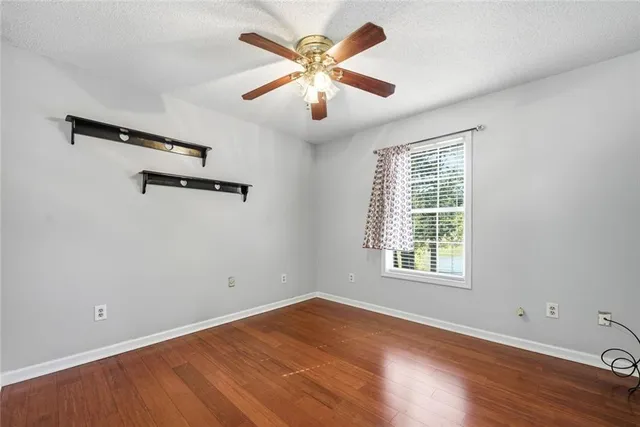 a view of a room with wooden floor