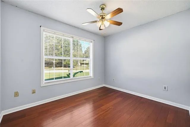 a view of an empty room with wooden floor