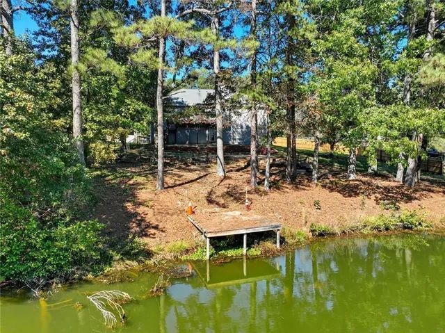 a view of a lake with a mountain and a yard