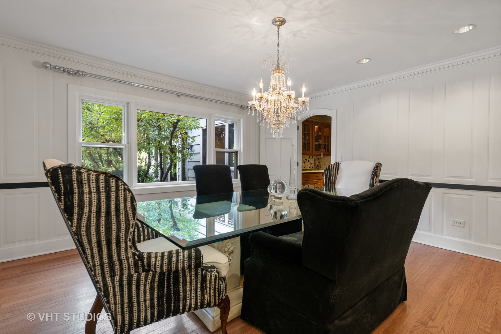 3423 Spring Road Oak Brook, IL 60523 - Photo 14 of 75 a view of a dining room with furniture a chandelier and wooden floor