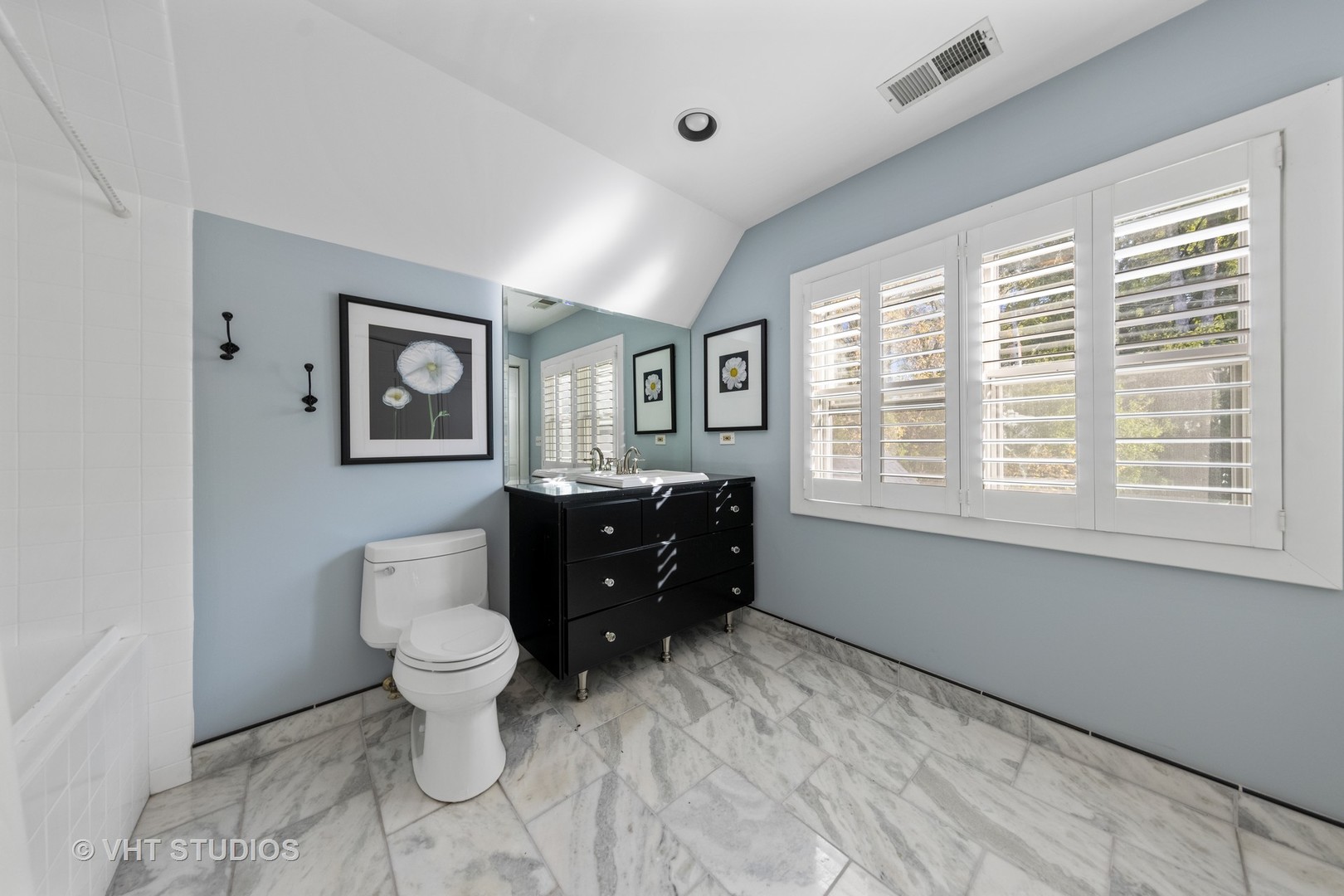 3423 Spring Road Oak Brook, IL 60523 - Photo 28 of 75 a room with a toilet a sink and a mirror