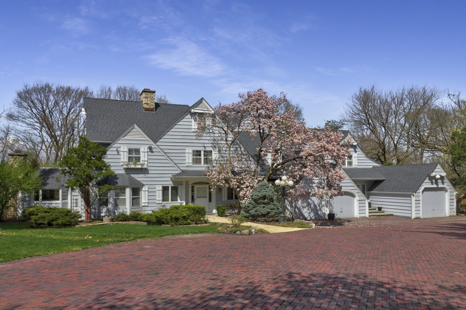 3423 Spring Road Oak Brook, IL 60523 - Photo 50 of 75 a front view of a house with a yard and garage