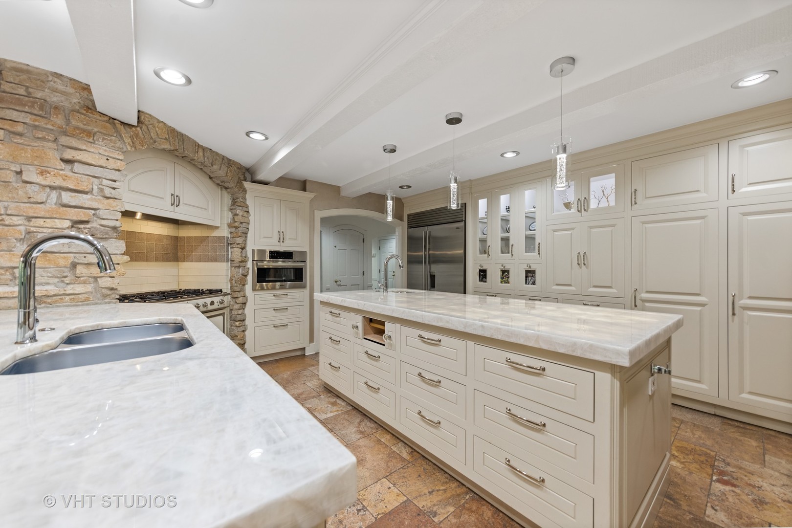 3423 Spring Road Oak Brook, IL 60523 - Photo 8 of 75 a large kitchen with kitchen island a sink stainless steel appliances and cabinets