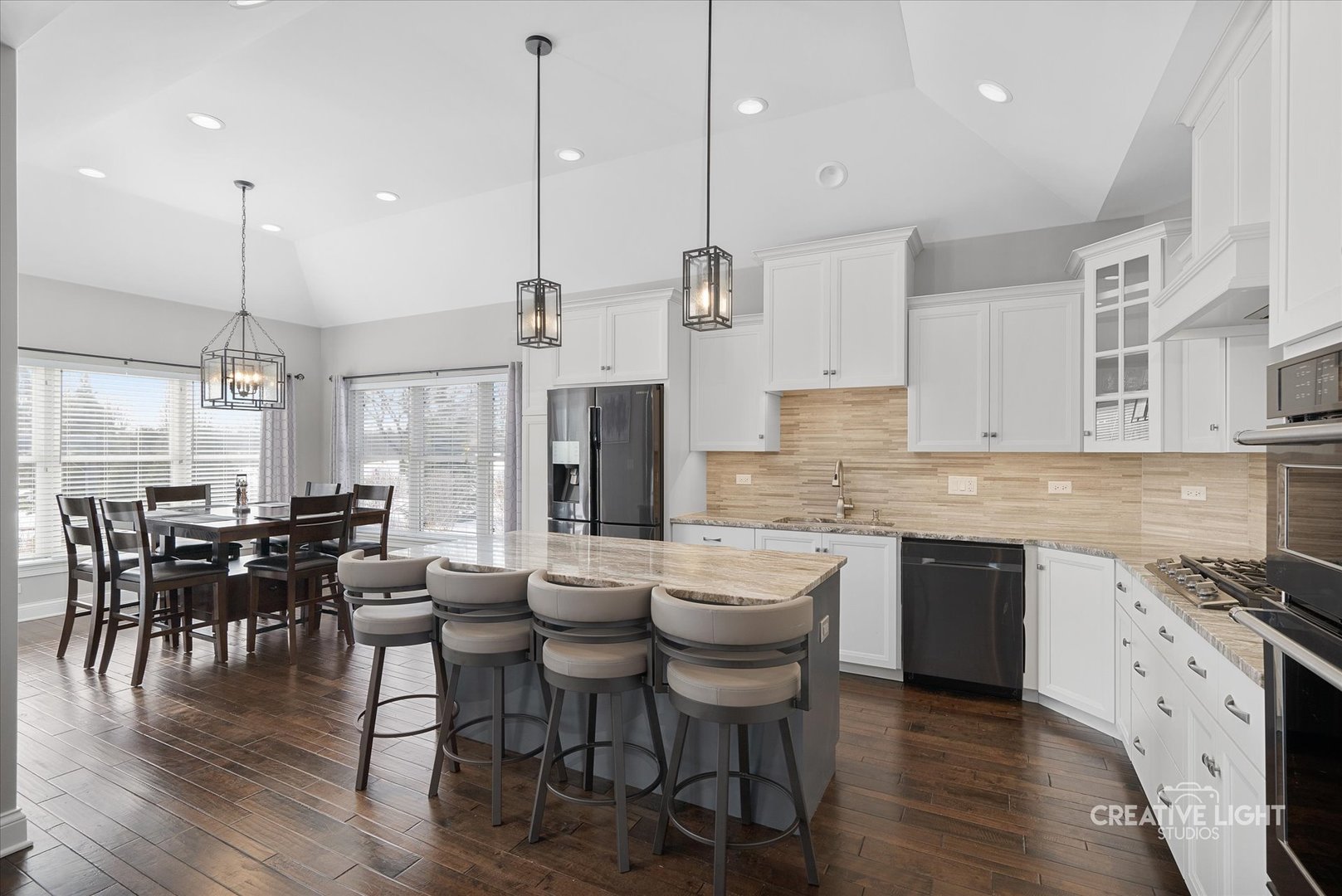 673 Greenfield Road Sugar Grove, IL 60554 - Photo 8 of 31 a kitchen with stainless steel appliances granite countertop a stove a refrigerator a kitchen island a dining table and chairs with wooden floor