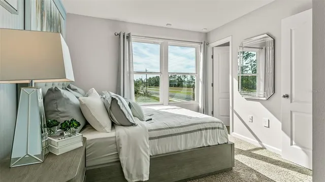 a bedroom with a bed and window