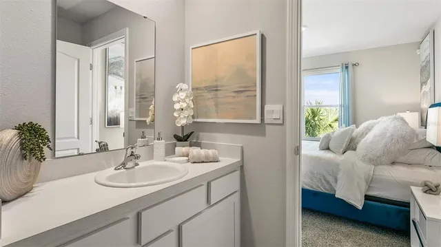 a en suite bathroom with sink and mirror